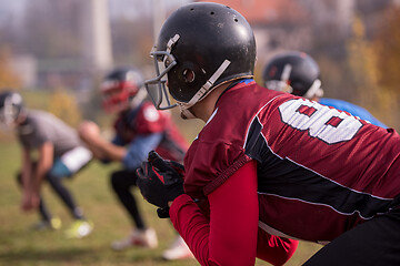 Image showing american football players stretching and warming up