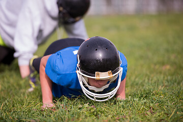 Image showing american football player doing push ups