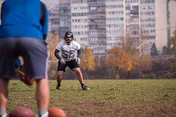 Image showing american football team with coach in action