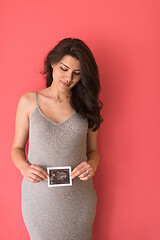 Image showing happy pregnant woman showing ultrasound picture