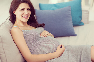 Image showing pregnant woman sitting on sofa at home