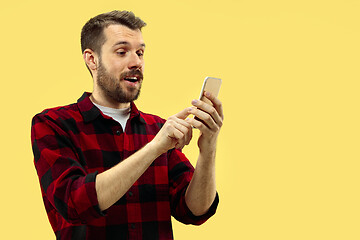 Image showing Half-length close up portrait of young man on yellow background.