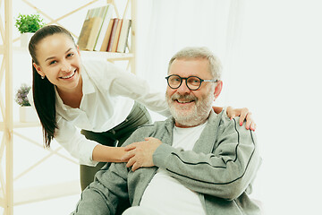 Image showing A daughter or granddaughter spends time with the grandfather