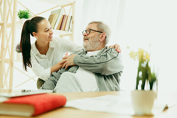 Image showing The visiting nurse taking care of senior man