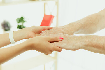 Image showing The visiting nurse taking care of senior man