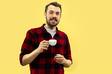 Image showing Half-length close up portrait of young man on yellow background.