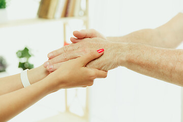 Image showing The visiting nurse taking care of senior man