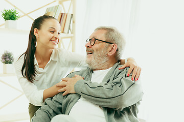 Image showing A daughter or granddaughter spends time with the grandfather