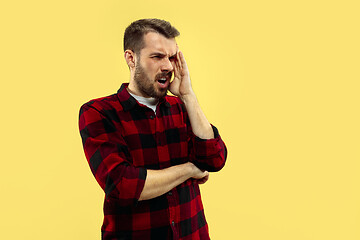 Image showing Half-length close up portrait of young man on yellow background.