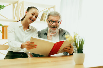 Image showing A daughter or granddaughter spends time with the grandfather