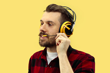 Image showing Half-length close up portrait of young man on yellow background.