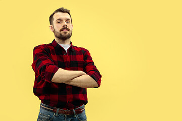 Image showing Half-length close up portrait of young man on yellow background.