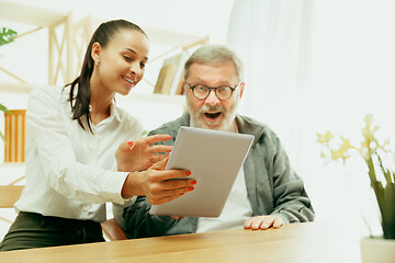 Image showing A daughter or granddaughter spends time with the grandfather