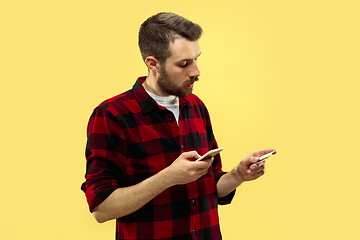 Image showing Half-length close up portrait of young man on yellow background.