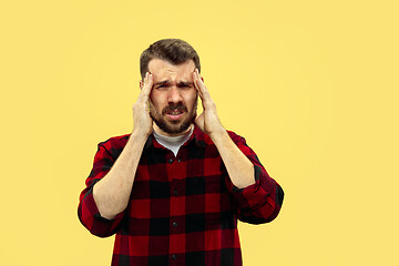 Image showing Half-length close up portrait of young man on yellow background.