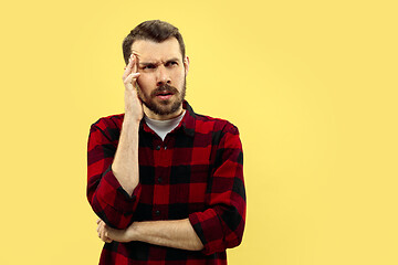 Image showing Half-length close up portrait of young man on yellow background.