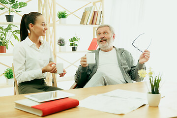 Image showing A daughter or granddaughter spends time with the grandfather