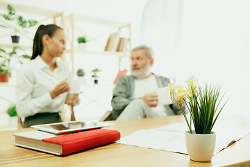 Image showing A daughter or granddaughter spends time with the grandfather