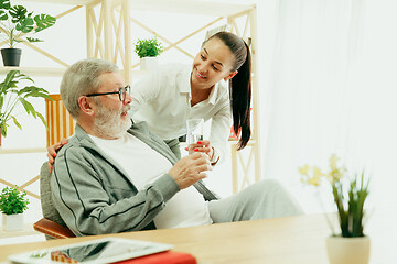 Image showing A daughter or granddaughter spends time with the grandfather