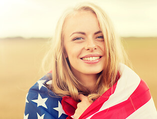 Image showing happy woman in american flag on cereal field