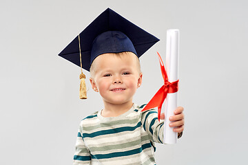 Image showing smiling little boy in mortar board with diploma