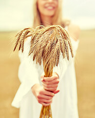 Image showing close up of happy woman with cereal spikelets