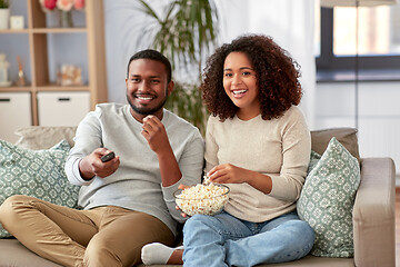 Image showing african couple with popcorn watching tv at home