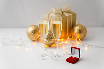 Image showing champagne and diamond ring in box on christmas