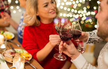 Image showing close up of friends with wine celebrate christmas