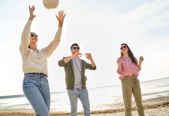 Image showing friends playing volleyball on beach in summer