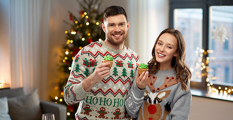 Image showing couple with cupcakes in ugly christmas sweaters