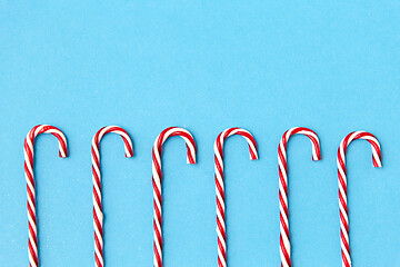 Image showing candy cane decorations on blue background