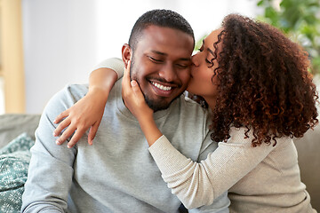 Image showing happy african american couple kissing at home