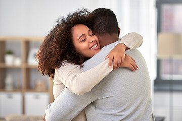 Image showing happy african american couple hugging at home