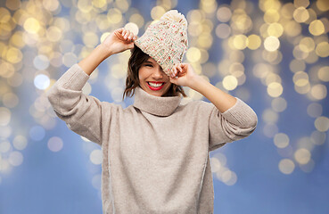 Image showing young woman in winter hat and sweater on christmas