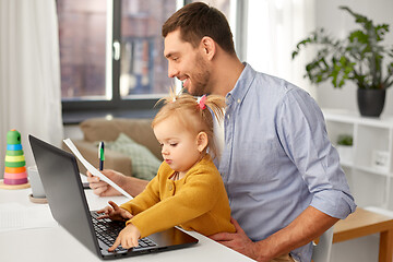 Image showing working father with baby daughter at home office