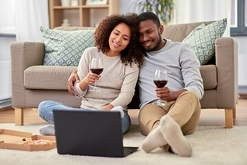 Image showing happy couple with laptop drinking red wine at home