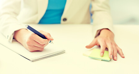 Image showing close up of woman with to notepad at office