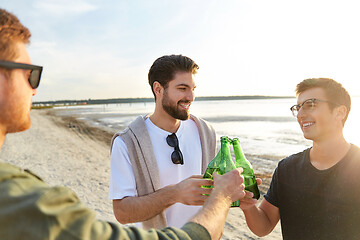 Image showing young men toasting non alcoholic beer on beach