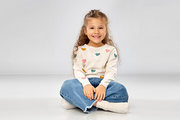 Image showing beautiful smiling girl sitting on floor