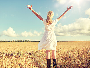 Image showing happy young woman in white dress on cereal field