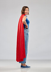 Image showing happy woman in red superhero cape