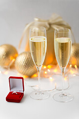 Image showing champagne and diamond ring in box on christmas