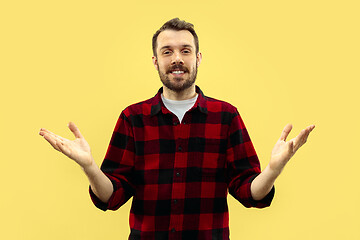Image showing Half-length close up portrait of young man on yellow background.
