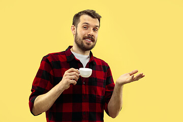 Image showing Half-length close up portrait of young man on yellow background.