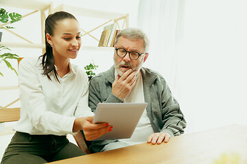 Image showing A daughter or granddaughter spends time with the grandfather