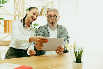 Image showing A daughter or granddaughter spends time with the grandfather