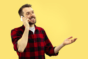 Image showing Half-length close up portrait of young man on yellow background.