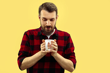 Image showing Half-length close up portrait of young man on yellow background.