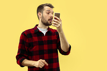 Image showing Half-length close up portrait of young man on yellow background.